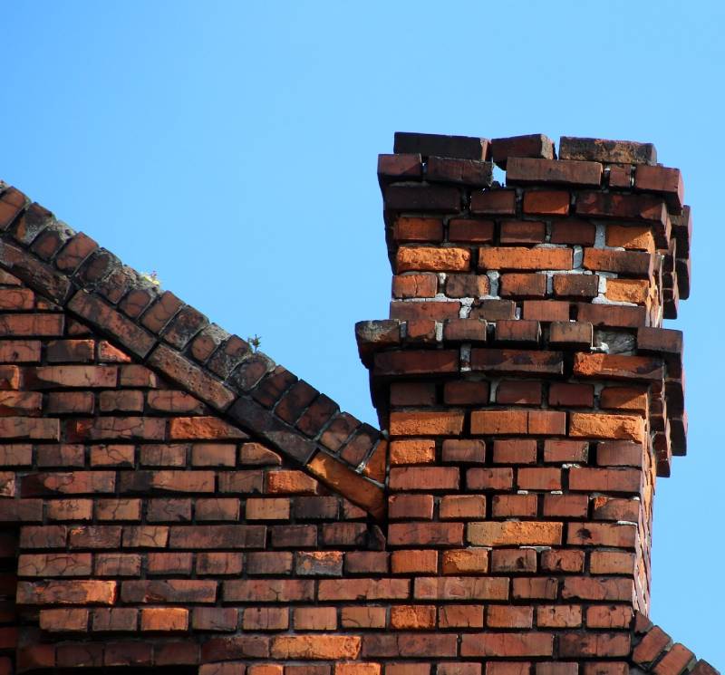 Damaged chimney on an Bartlett home showing cracks and missing mortar